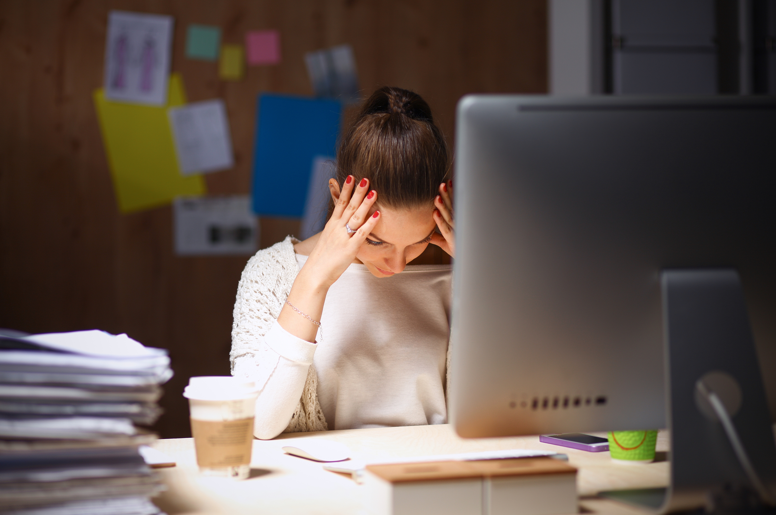 stressed businesswoman sitting at her desk