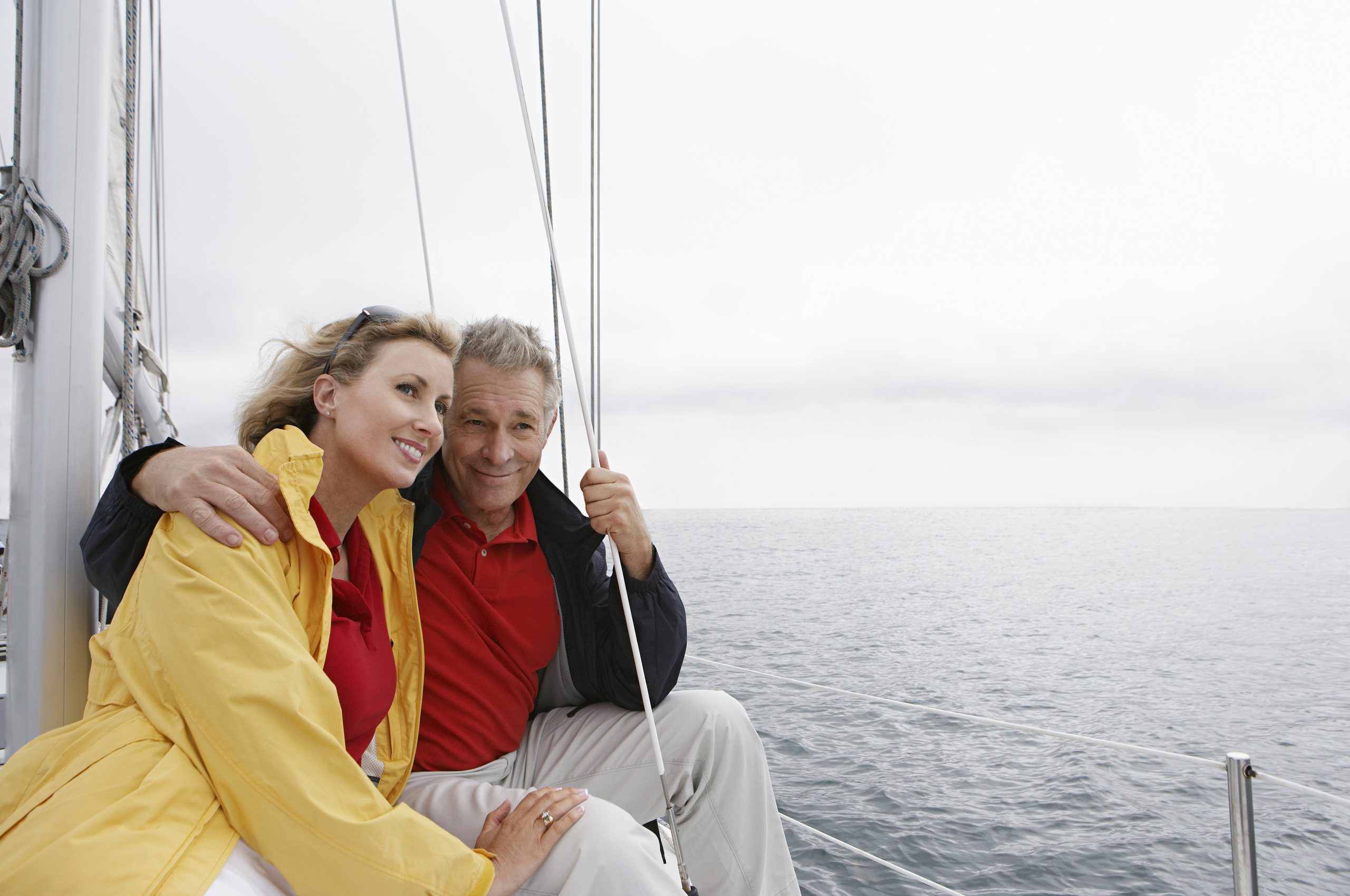 Happy middle-aged couple sailing