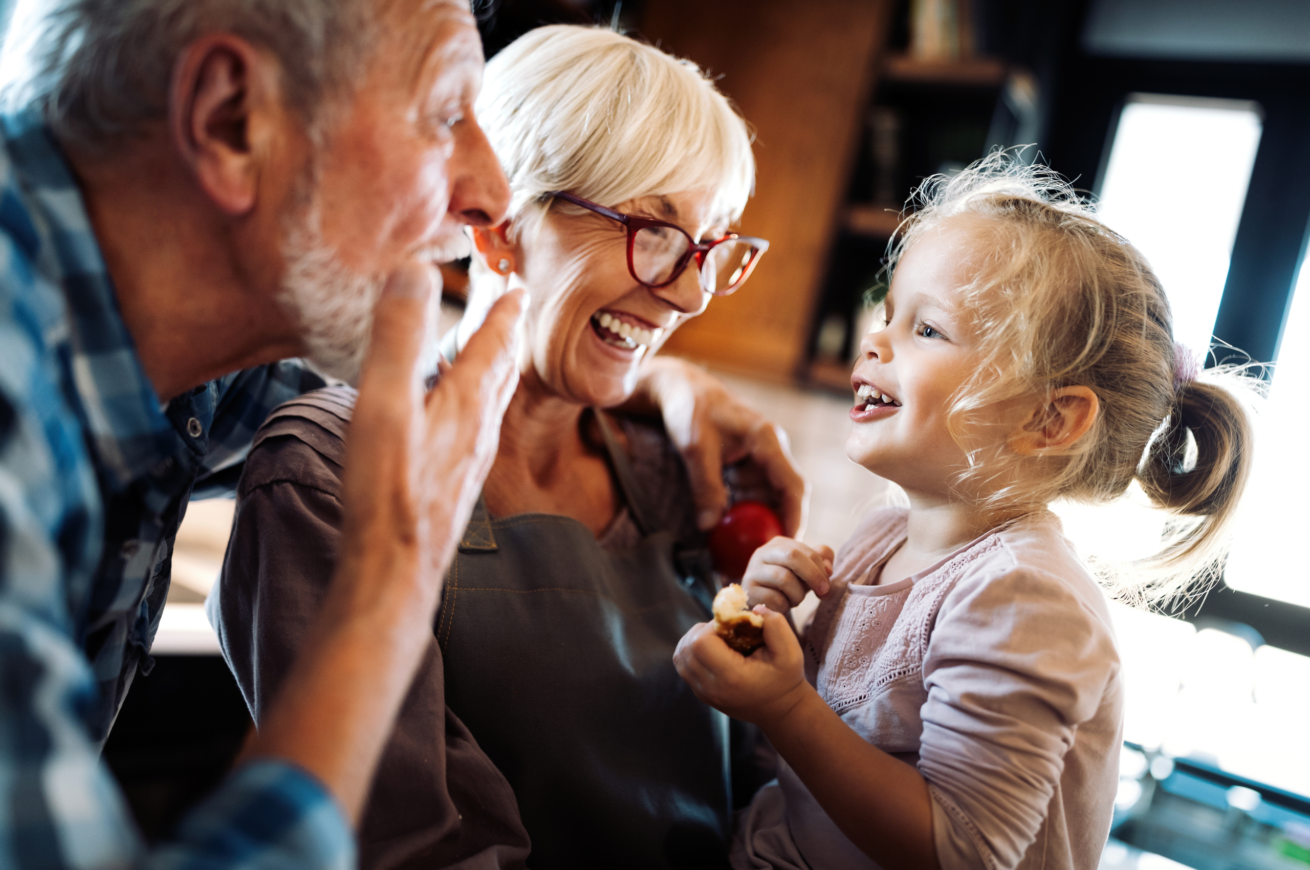 Middle-aged couple playing with granddaughter