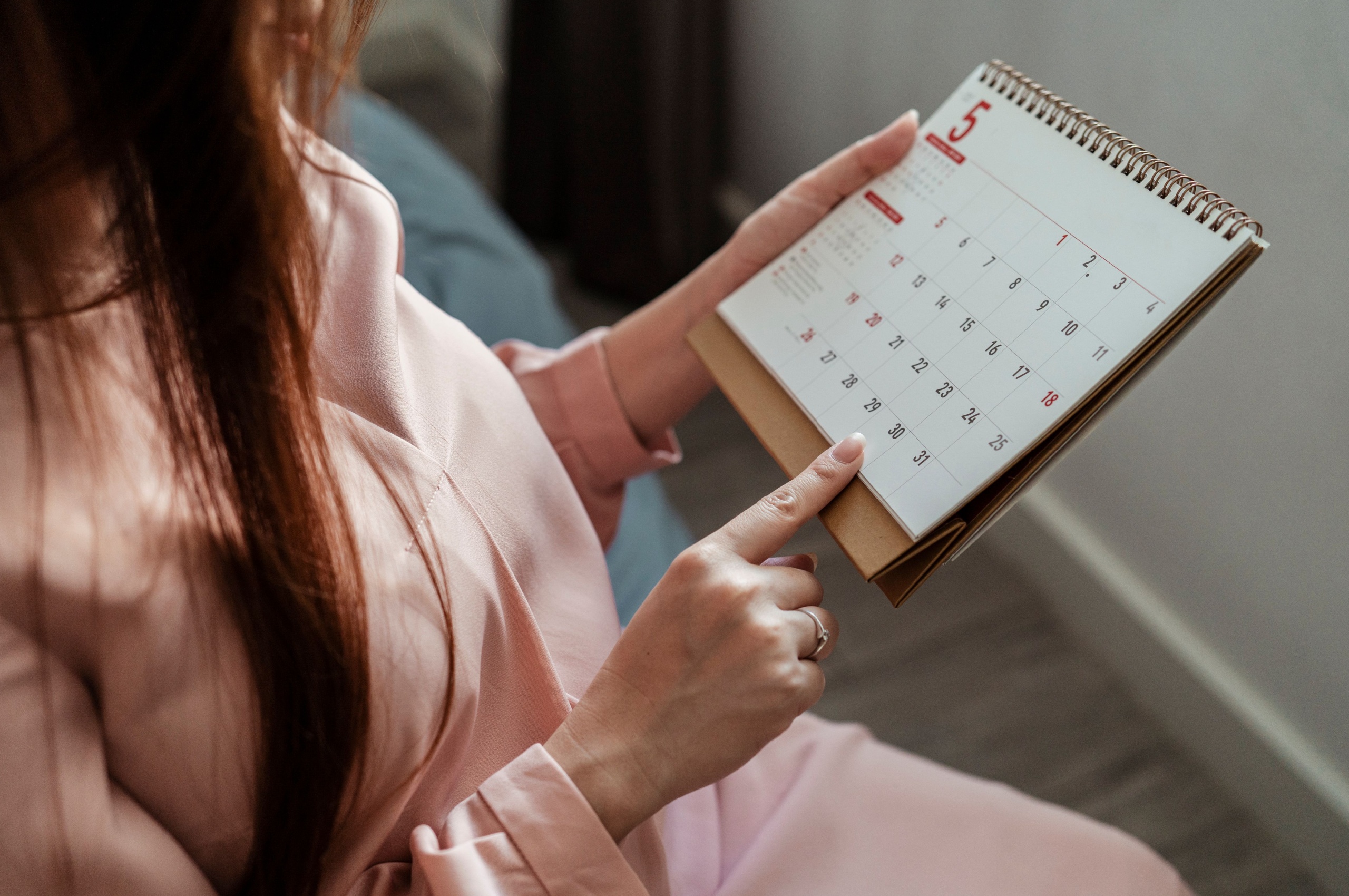 A woman looking at a calendar